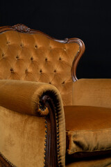 golden Isolated Bergère armchair on black background, detail