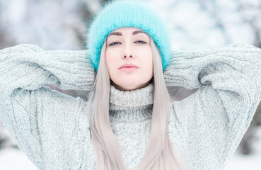 Close up photo of  young woman European appearance in blue hat with beautiful eyes and ring in the nose