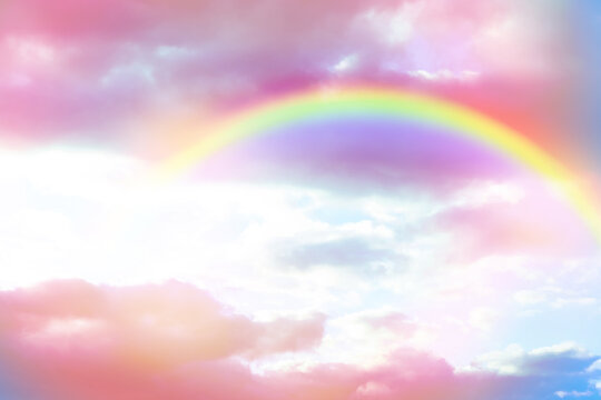 Amazing sky with rainbow and fluffy clouds, toned in unicorn colors