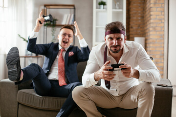 Businessmen playing video games in the office. Colleagues relaxing after meeting