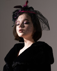 brunette in a black fur coat at a photo shoot