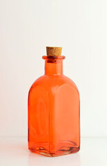 Orange glass bottle on white background.	