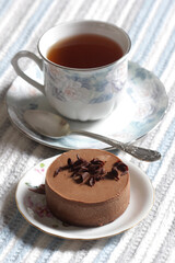 Close-up of chocolate mousse and a cup of tea on the table