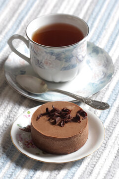 Close-up of chocolate mousse and a cup of tea on the table
