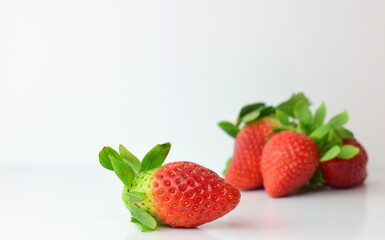 Fresh strawberries close-up, white background and copy space.