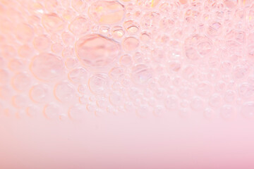 Blurred abstract light pink background with bubbles. The concept is summer, soft drinks, freshness. For the backing of a site or mobile application.