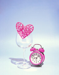 A heart in a wine glass with an alarm clock that reminds you not to miss an important meeting