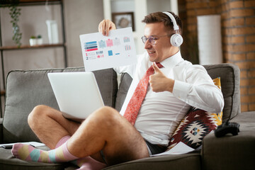 Businessman working online, wearing suit and no pants. Young man having video call. Businessman...