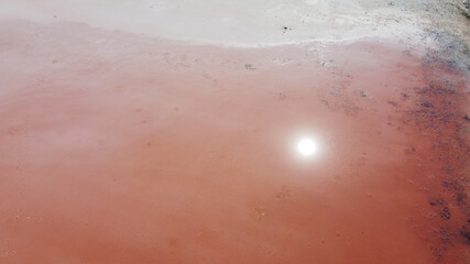 Fototapeta premium Aerial top view of beautiful salt lake with pink water. View of pink lake from flying drone. Drone copter photography from above