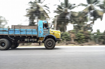 truck on the road , people are running out of time, fast , racing