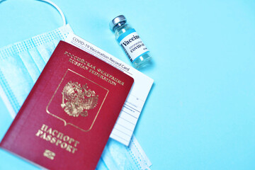 Blurred COVID-19 Vaccination Record card, Passport of a Russian citizen and Medical Mask. Immune...