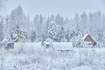 frame house in the forest in winter