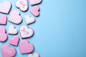 Delicious heart shaped cookies on light blue background, flat lay with space for text. Valentine's Day