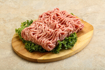 Raw pork minced meat over board