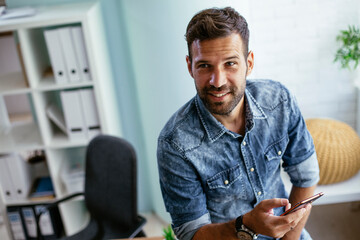 Businessman in office using the phone. Handsome businessman working in the office.