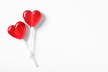 Sweet heart shaped lollipops on white background, flat lay with space for text. Valentine's day...