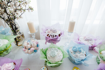 Beautiful Easter cakes on a decorated light table. A light holiday of Easter.