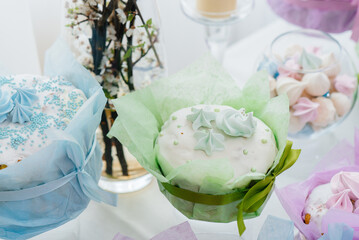 Beautiful Easter cakes on a decorated light table. A light holiday of Easter.