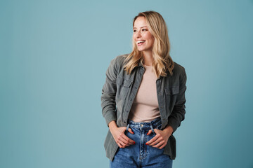 Happy beautiful blonde girl smiling and looking aside