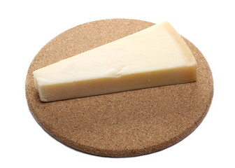 Cheese wedge, Italian Grana Padano block on cork mat, plug isolated on white background