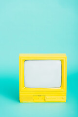 bright yellow retro tv on turquoise background