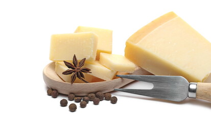 Cheese wedge slices with star anise, allspice pimento pepper pile and fork, Italian Grana Padano pieces isolated on white background