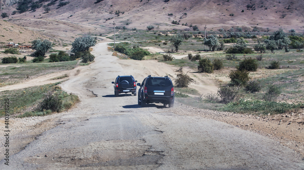 Canvas Prints suvs drive along the old road to the mountains