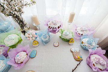 Beautiful Easter cakes on a decorated light table. A light holiday of Easter.