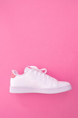 white sneaker on colored background with copy space