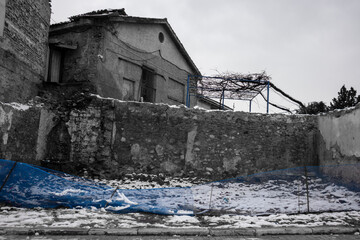 Fototapeta premium old abandoned houses with blue fence