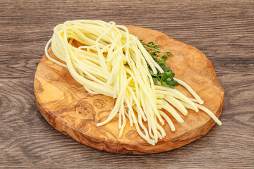 Chechil spaghetti cheese over board