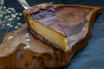 Slice of delicious fresh Tartellette creme brulee a la vanille on a wooden plate.