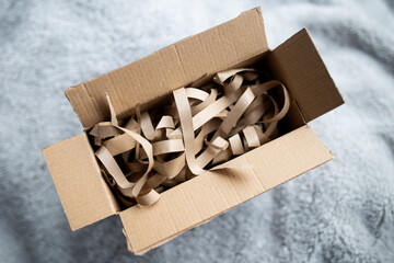 Cardboard box for eco gift filled with shredded paper. Eco-friendly gift packaging, paper...
