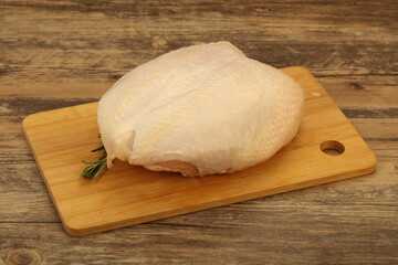 Raw whole chicken breast with skin