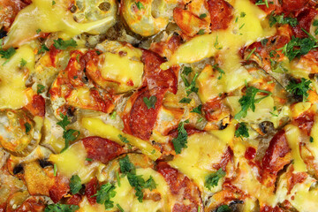 Fresh homemade pizza with sausage, cheese and pickles top view close-up, texture, background