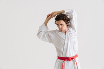 Young caucasian sportsman dressed in kimono practice in karate