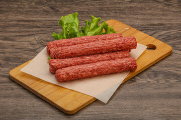 Raw beef sausages with spices