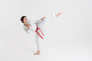 Young caucasian sportsman dressed in kimono practice in karate