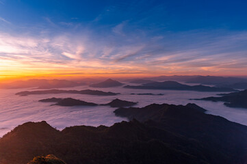 Landscape and starscape of the mountain and sea of mist in winter sunrise view from top of Phu Chi Dao mountain , Chiang Rai, Thailand