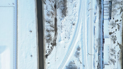 snow-covered road and railway tracks