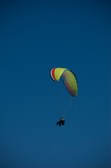 Fototapeta na wymiar paragliding alone in blue sky without any clouds