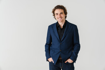 Fototapeta premium Joyful handsome man in jacket smiling and looking at camera