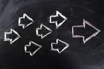 Arrows drawn in chalk on the board. Leadership concept