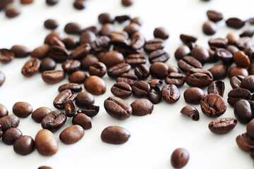 roasted coffee beans on white wooden background