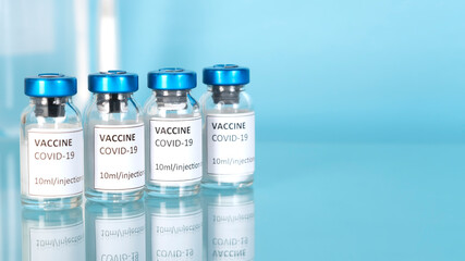 Vaccine vials against the coronavirus covid-19 and pandemic concept. Stop coronavirus. Covid-19 vaccination with vaccine bottle. No quarantine. Copy space. Horizontal orientation.