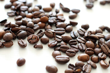 roasted coffee beans on white wooden background