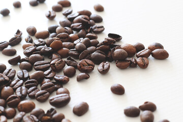 roasted coffee beans on white wooden background