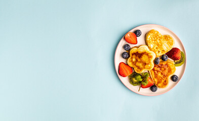 Valentine's day flat lay with heart shaped pancakes on a blue background. Valentine's Day concept. Top view. Banner. Copy space