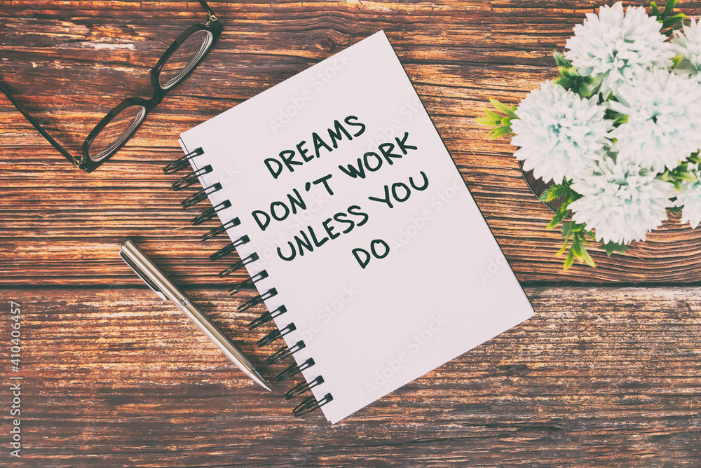 Wall mural motivational and inspirational quotes text on notepad - dreams don't work unless you do.