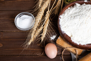 Fototapeta na wymiar Ingredients for baking on a wooden table. Flour, eggs, wheat, salt. Top view.